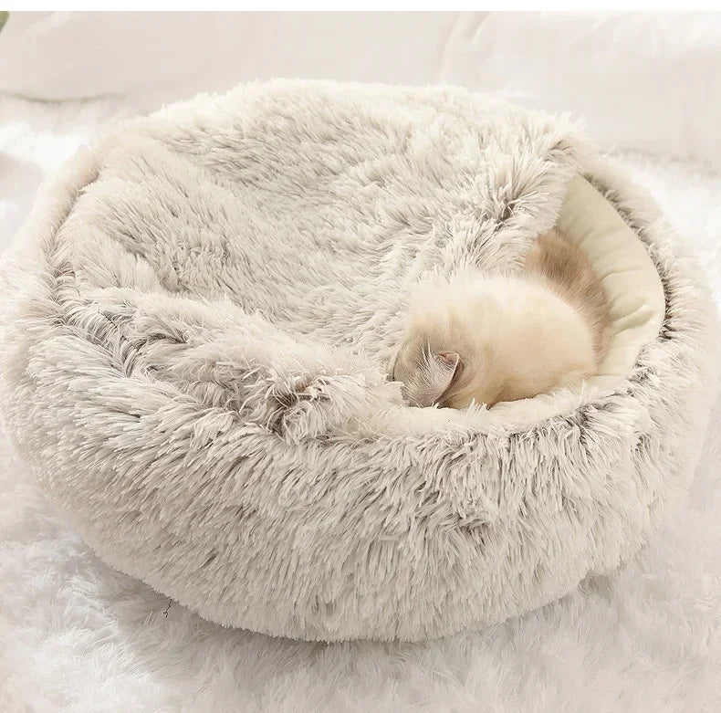 Fluffy pet bed with a cat inside on a soft white background