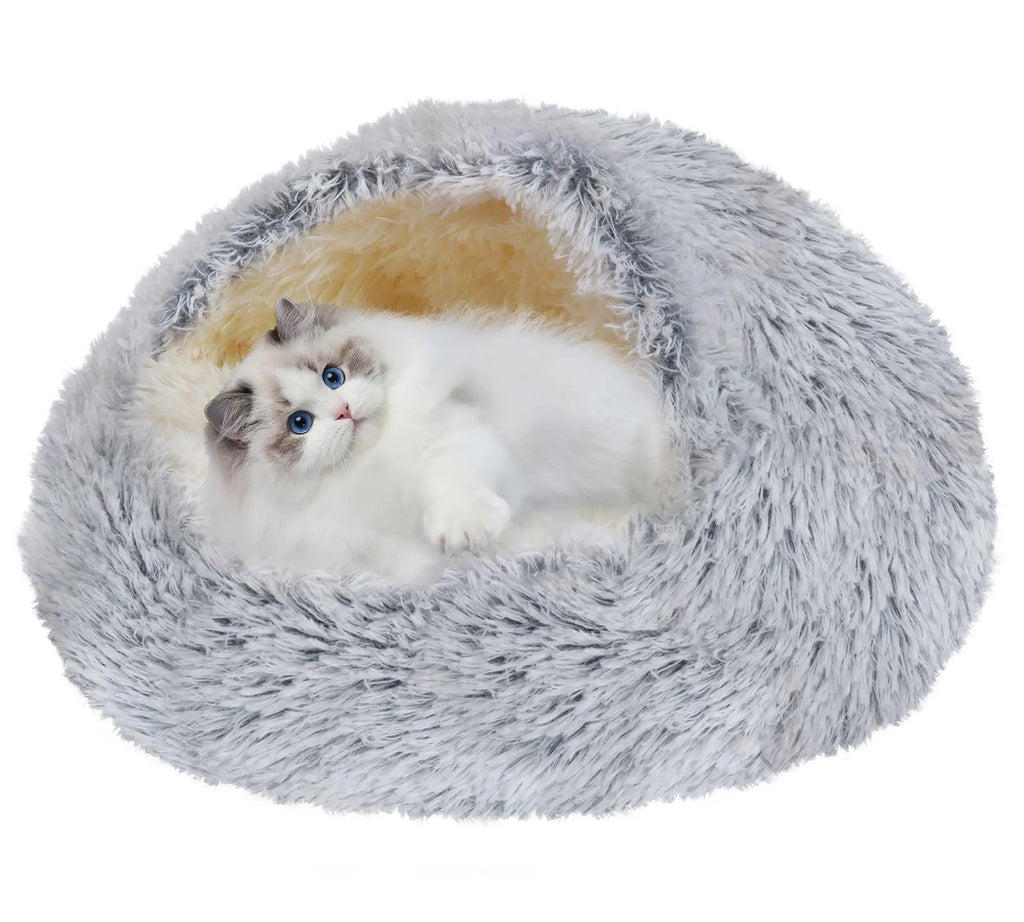A fluffy gray pet bed with a white and gray cat lying inside on a plain white background.