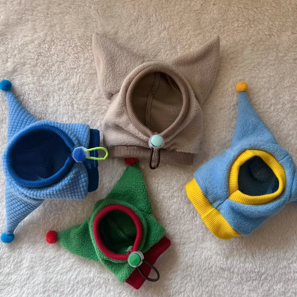 Colorful cat hats on a textured surface