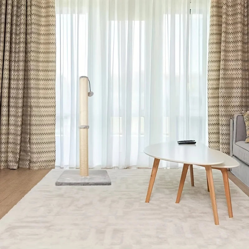 Living room with a cat tree, coffee table, and patterned curtains.