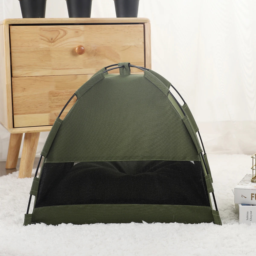 Green tent on a white surface with a wooden cabinet in the background