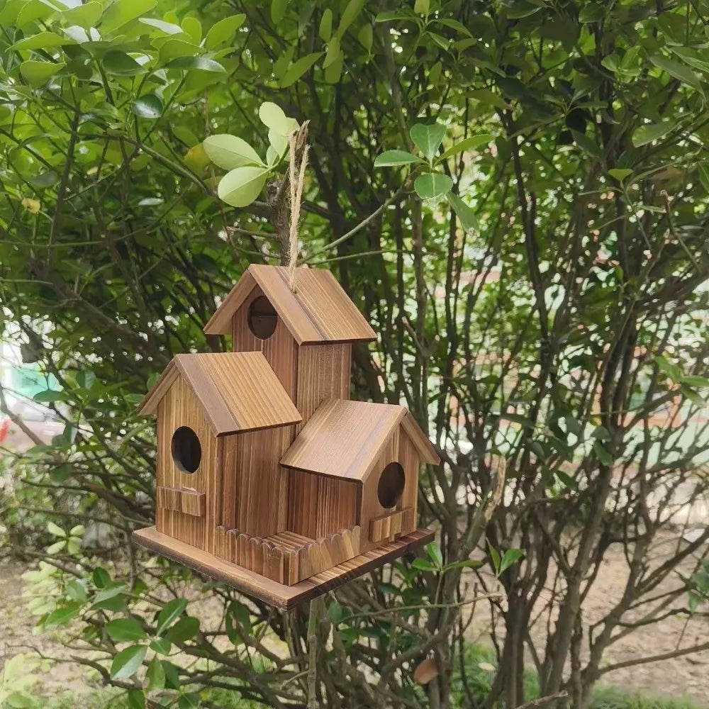 Wooden birdhouse hanging from a tree branch