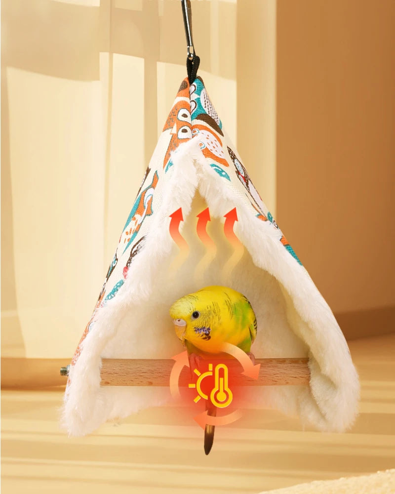 Colorful pet hammock with a parakeet inside on a wooden surface.