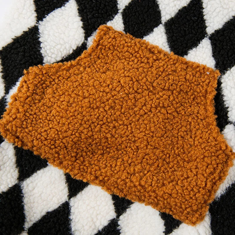 Brown textured rug on a black and white checkered background