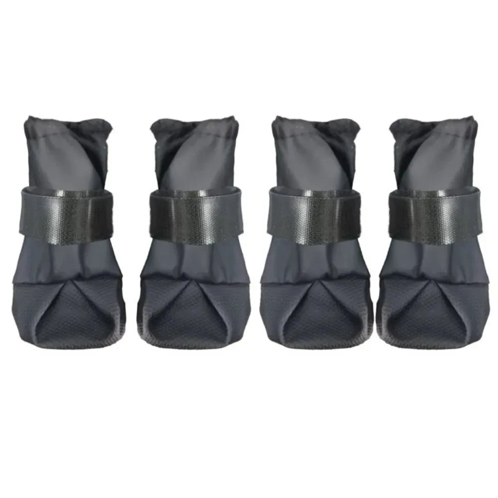 Four dark gray dog boots arranged in a row on a plain white background.