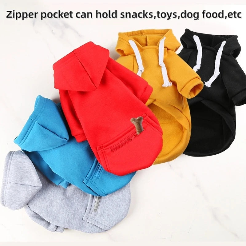 Stack of colorful pet hoodies with zipper pockets on a white background