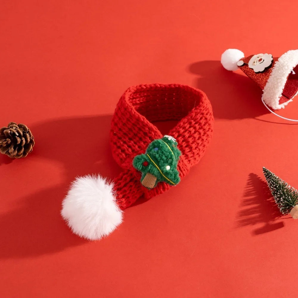 Red knitted headband with green tree and white pom-pom on a red background