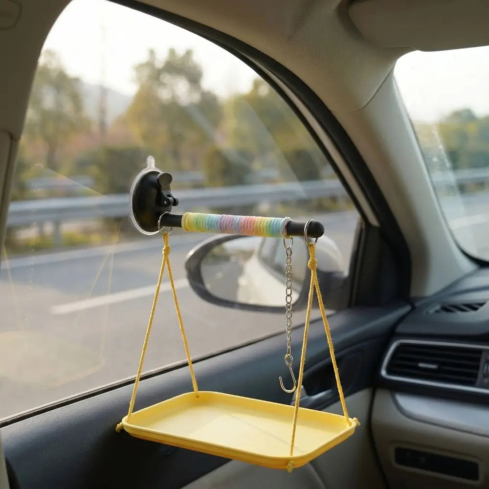 Yellow car tray with a colorful handle attached to a car's sun visor.
