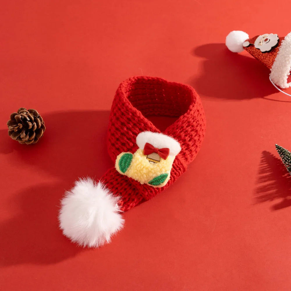 Red knitted baby bootie with white pom-pom on a red background