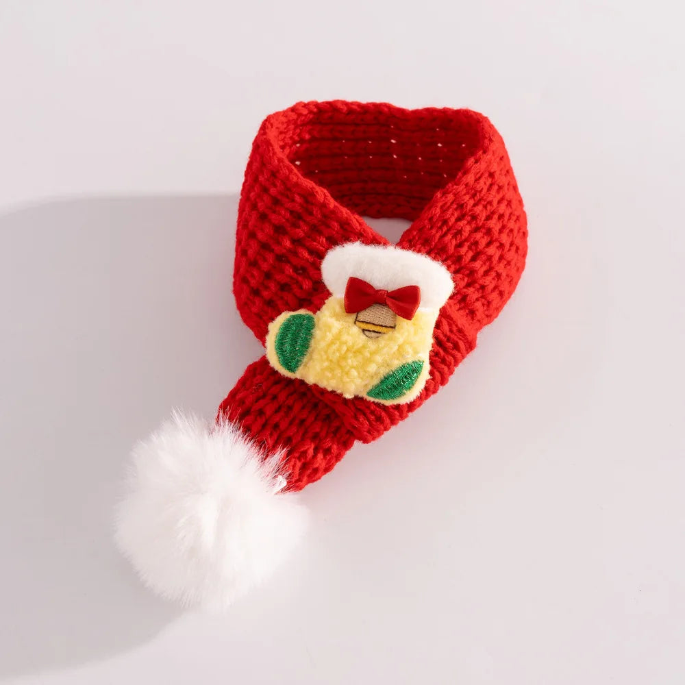 Red knitted scarf with a decorative bow and white fur trim on a light gray background