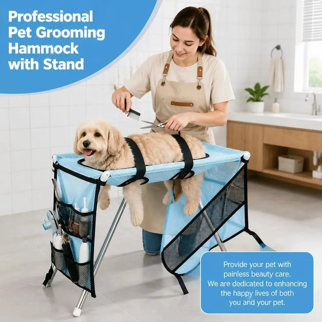A woman grooming a small cream-colored dog on a light blue and black mesh pet grooming hammock stand in a bright bathroom setting. The stand features side pockets holding grooming tools.