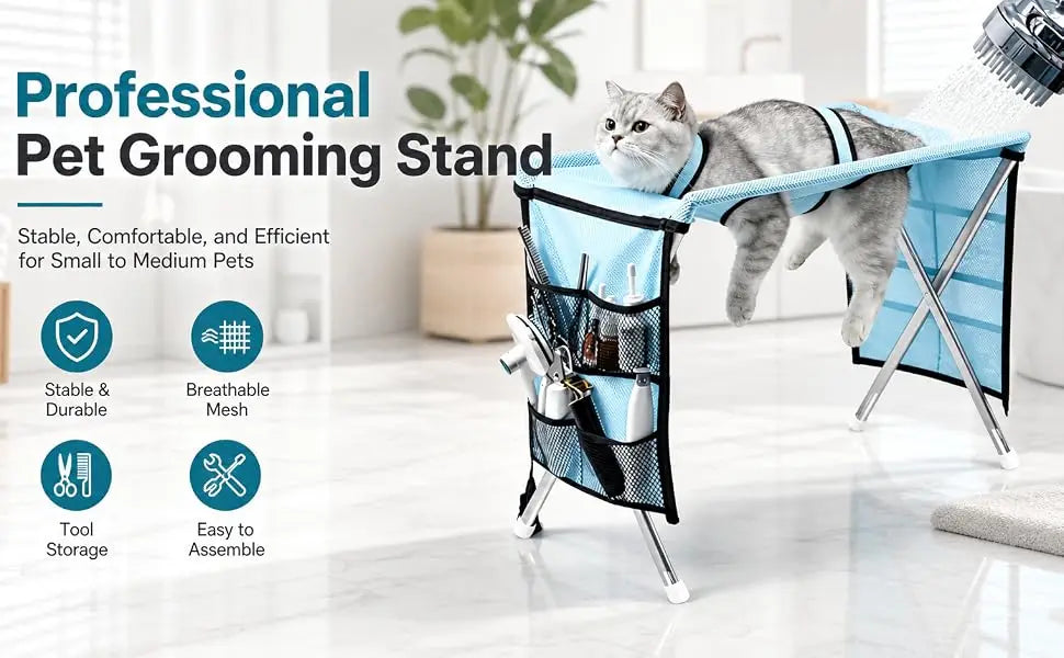 A gray cat lies on a blue and black pet grooming table with a grooming brush hanging in the front mesh pocket. The scene is set in a bright, modern room with text callouts and feature icons on the left.