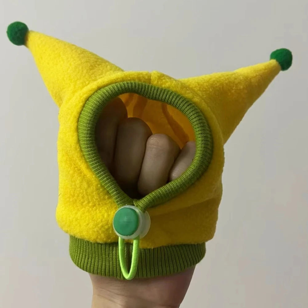 Yellow and green costume with animal ears held by a hand against a plain background