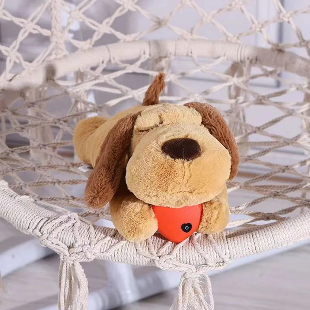 Plush dog toy with a red ball inside a hammock