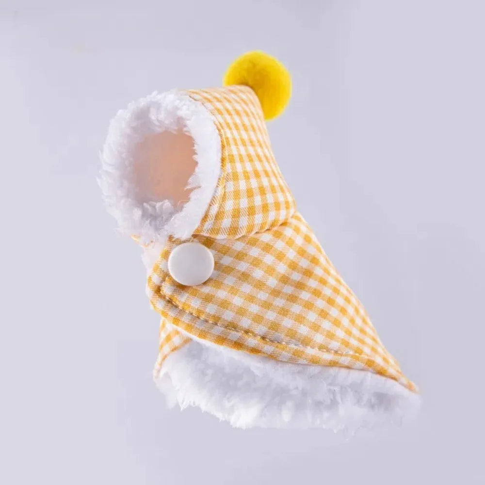 A small yellow and white gingham pet hood with white faux fur trim and a yellow pom-pom, shown on a light gray background.