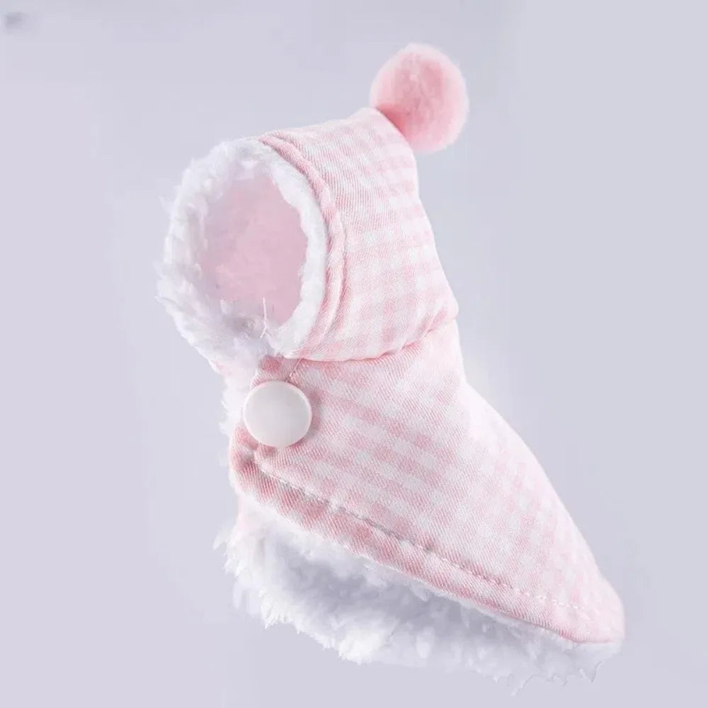 A pink and white checkered pet hood with a white faux-fur trim and a small white button, shown on a light gray background.