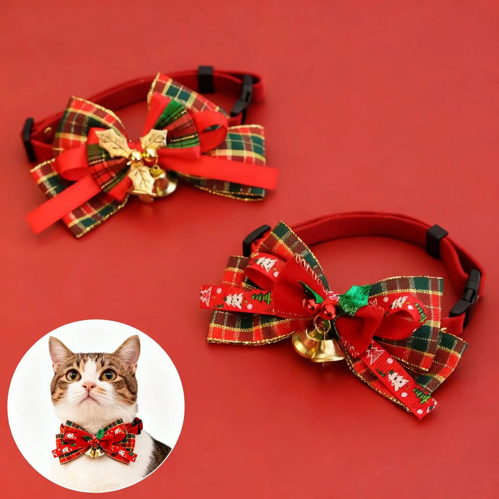 Two red pet collars with large holiday bow accessories, shown on a red background. Each bow has plaid ribbon in green, yellow, and red, a gold bell, and a small green accent.