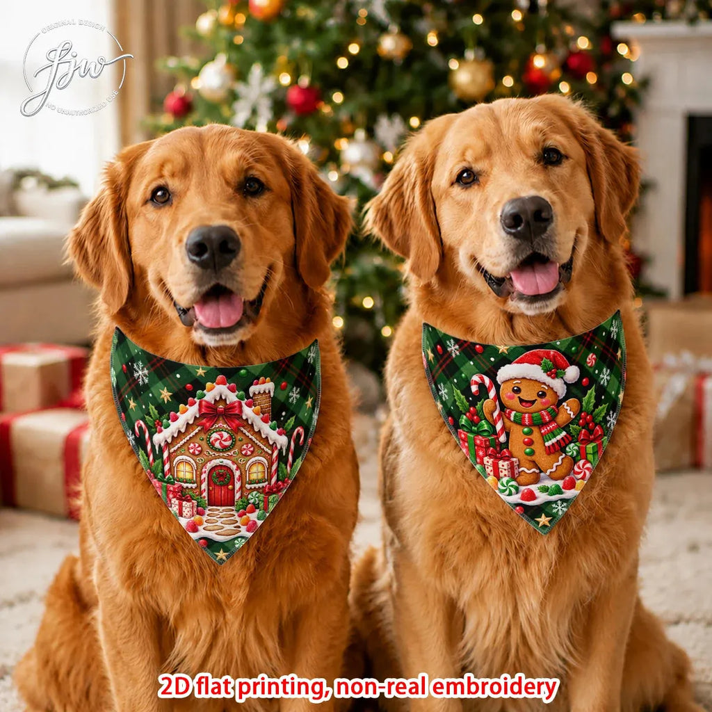 Two golden retriever dogs wearing matching Christmas-themed bandanas in a festive holiday setting with a decorated Christmas tree in the background. The bandanas feature a gingerbread house and a gingerbread man design with green, red, and white colors.