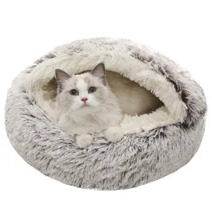 A fluffy gray and cream cat bed with a white cat sitting inside, shown against a plain white background.