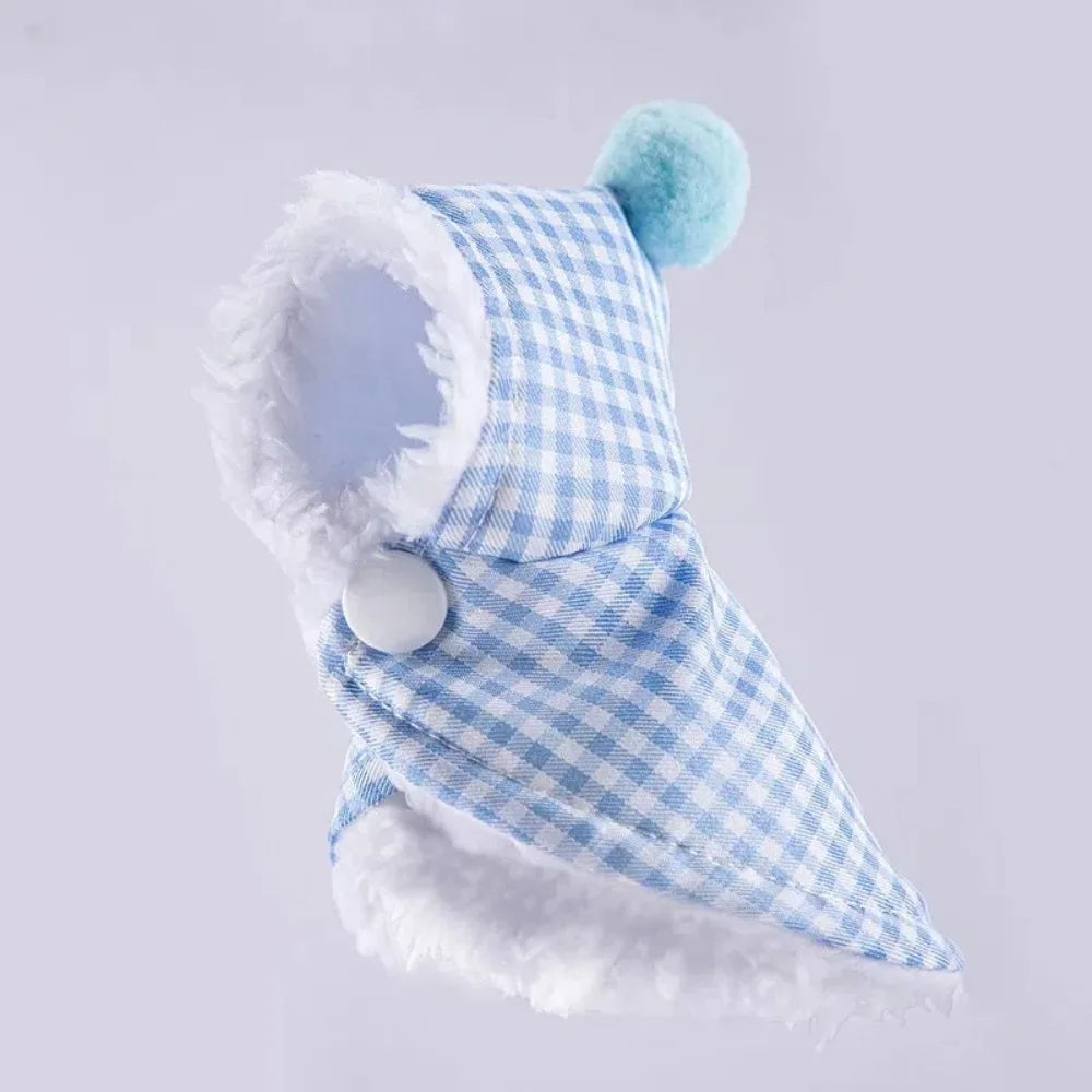 A light blue and white gingham pet hood with white faux fur trim and a light blue pom-pom on top, shown against a light gray background.