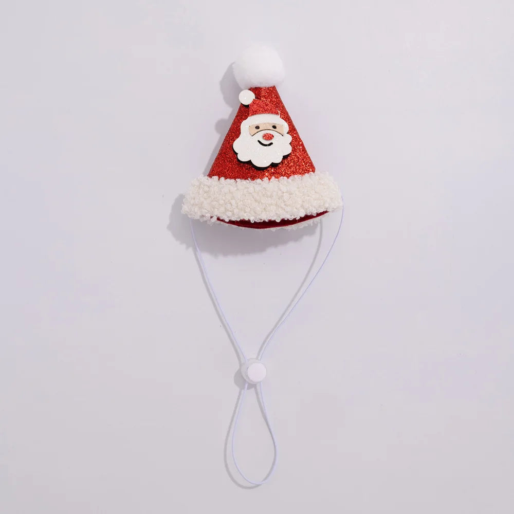 A festive Santa hat phone strap featuring a red glittery hat with white faux fur trim, a white pom-pom, and a smiling Santa face patch. It includes a white elastic cord with a snap button closure, shown against a plain light gray background.