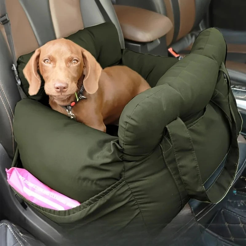 Dog sitting in a green pet car seat inside a vehicle.