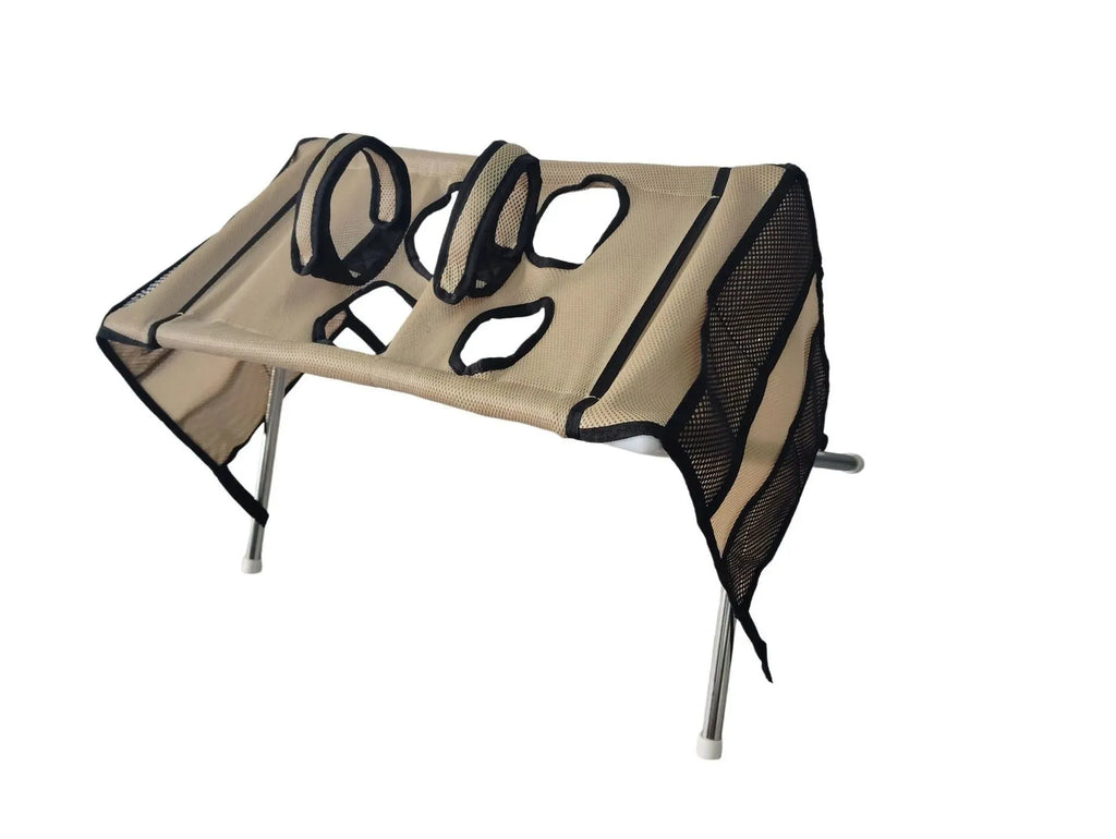 A beige and black dog harness cover with mesh panels and metal support legs, shown on a plain white background.