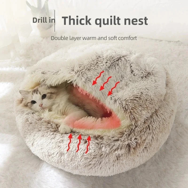 A fluffy cat bed with a white cat curled up inside, shown on a soft white blanket. Text at the top reads 'Drill in Thick quilt nest' and 'Double layer warm and soft comfort,' with red arrows highlighting the plush texture.