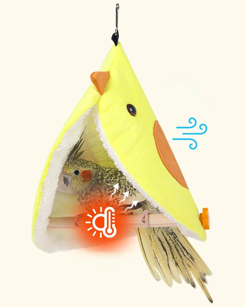Yellow bird-shaped pet house with a parrot inside on a white background
