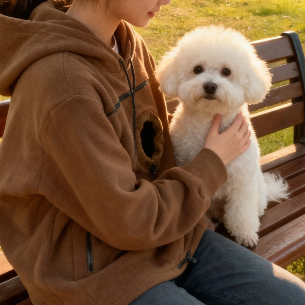 Person sitting on a bench with a small white dog