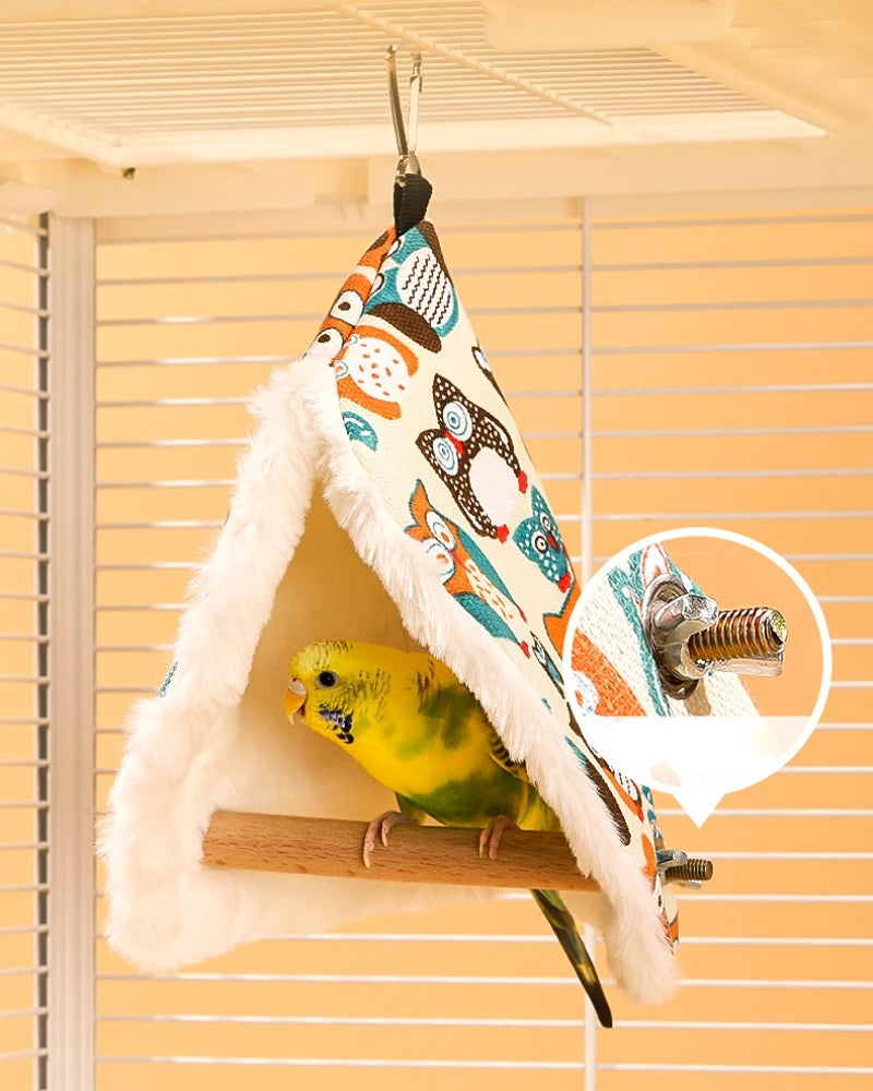 Bird perched on a colorful bird nest with a close-up of the hanging mechanism.