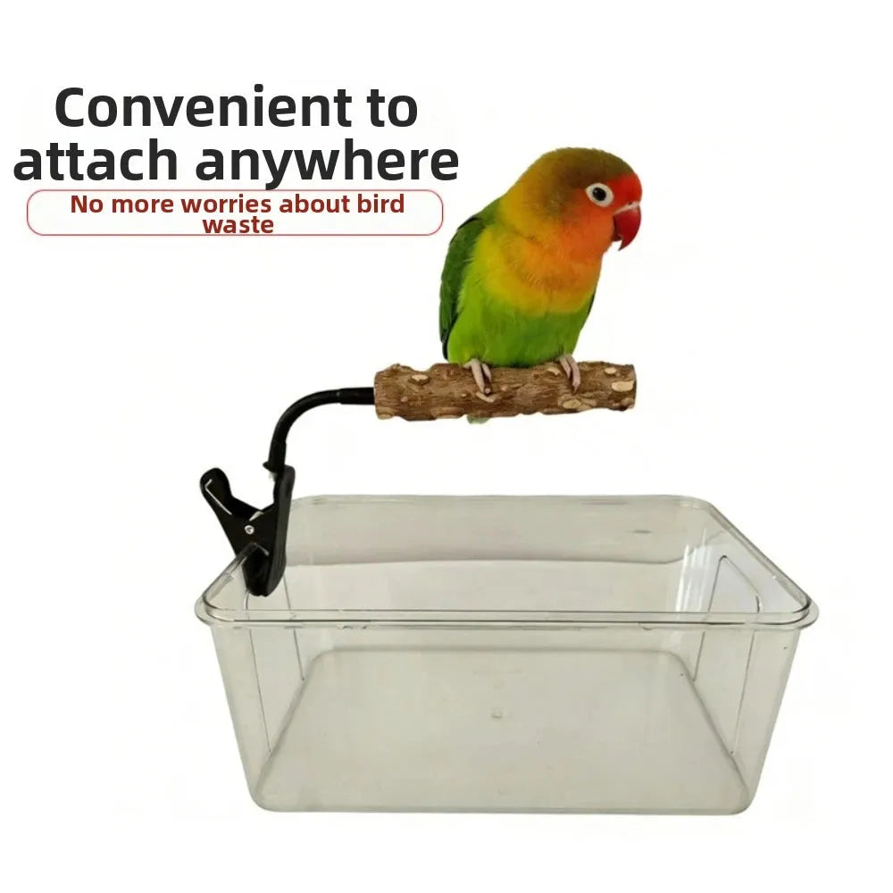 A clear plastic bird storage box with a black clip, shown with a small green-and-orange lovebird perched on a branch attached to the clip. Text on the image says it is convenient to attach anywhere and mentions no more worries about bird waste.