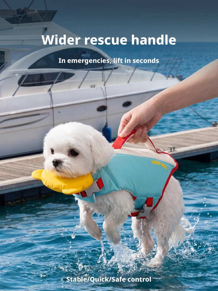 A small white dog in a water setting wearing a teal and red life jacket, with a human hand holding the handle. A white yacht and dock are visible in the background, with marketing text at the top and bottom.