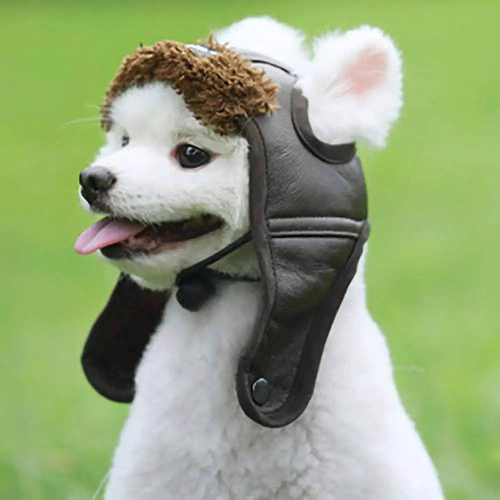Dog wearing a brown leather helmet with ear flaps against a green background