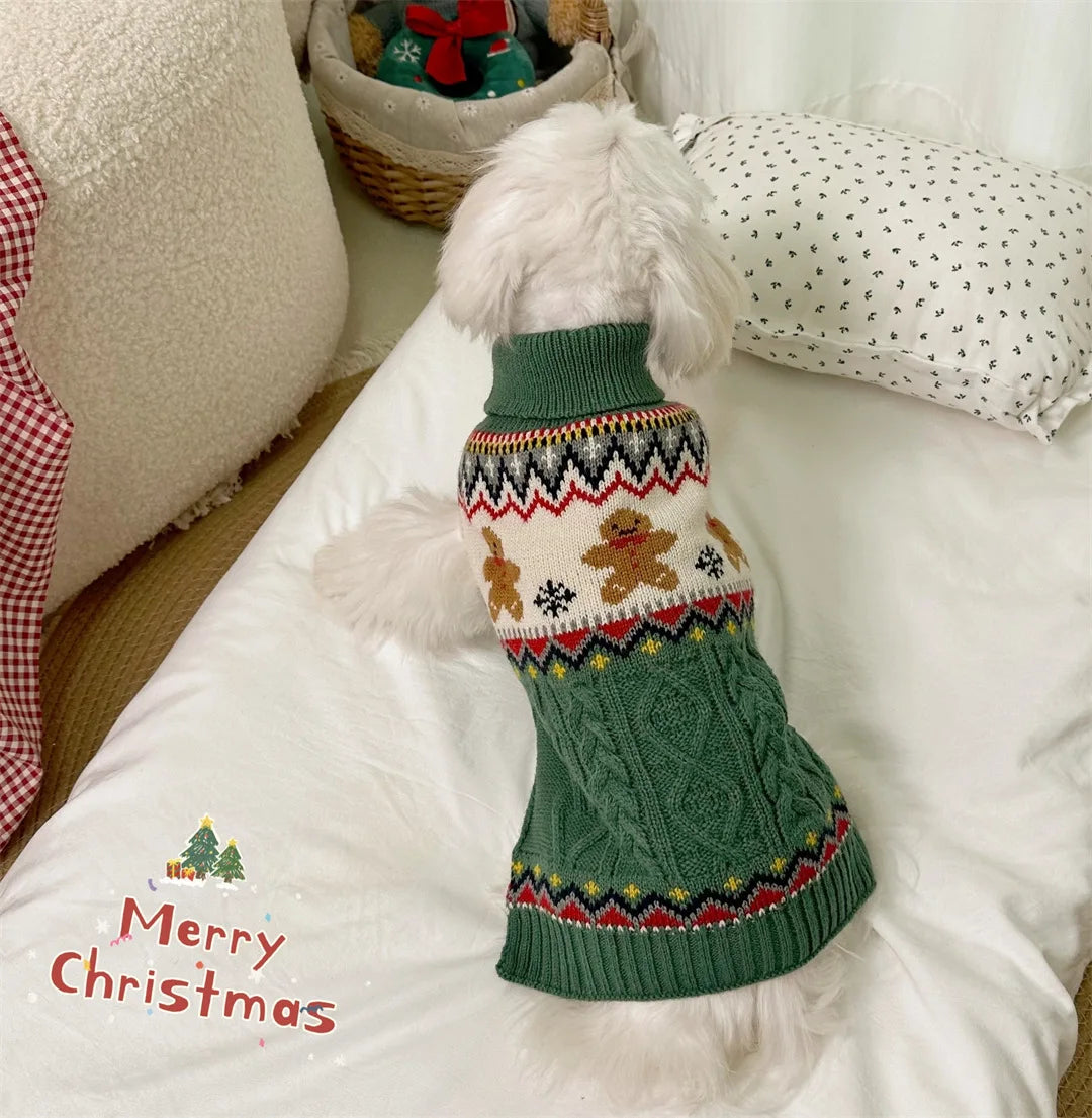 Dog wearing a green Christmas-themed sweater on a white couch with 'Merry Christmas' text.