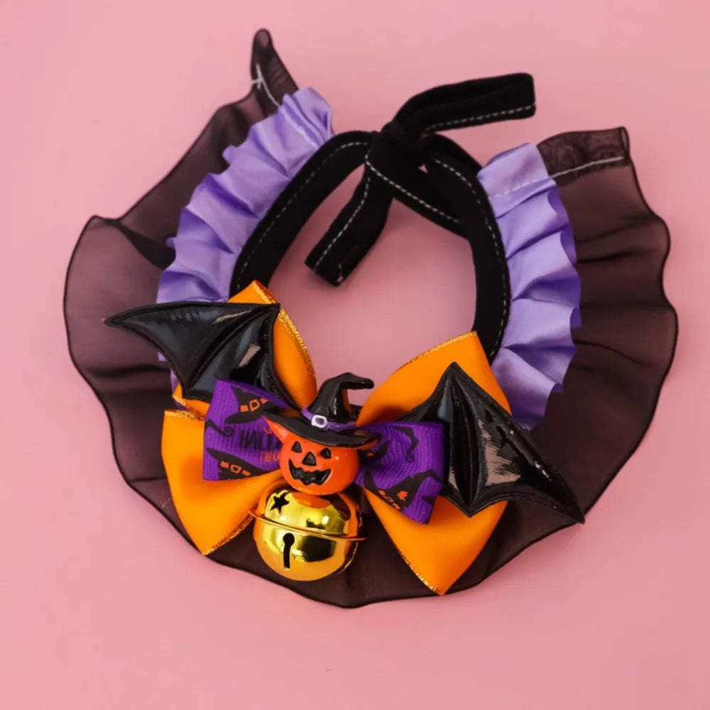 Halloween-themed pet collar with purple ribbons, black bats, and a gold bell on a pink background