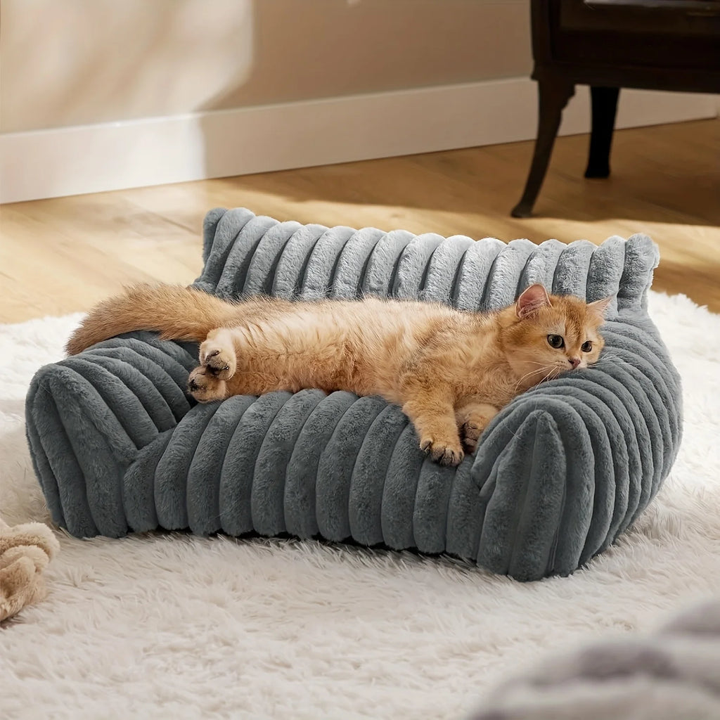 Cat lying on a gray pet bed in a home setting