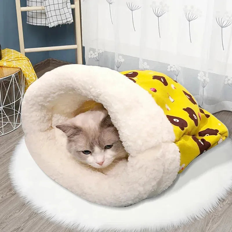 Cat lying in a white pet bed with a yellow cushion featuring brown paw prints.