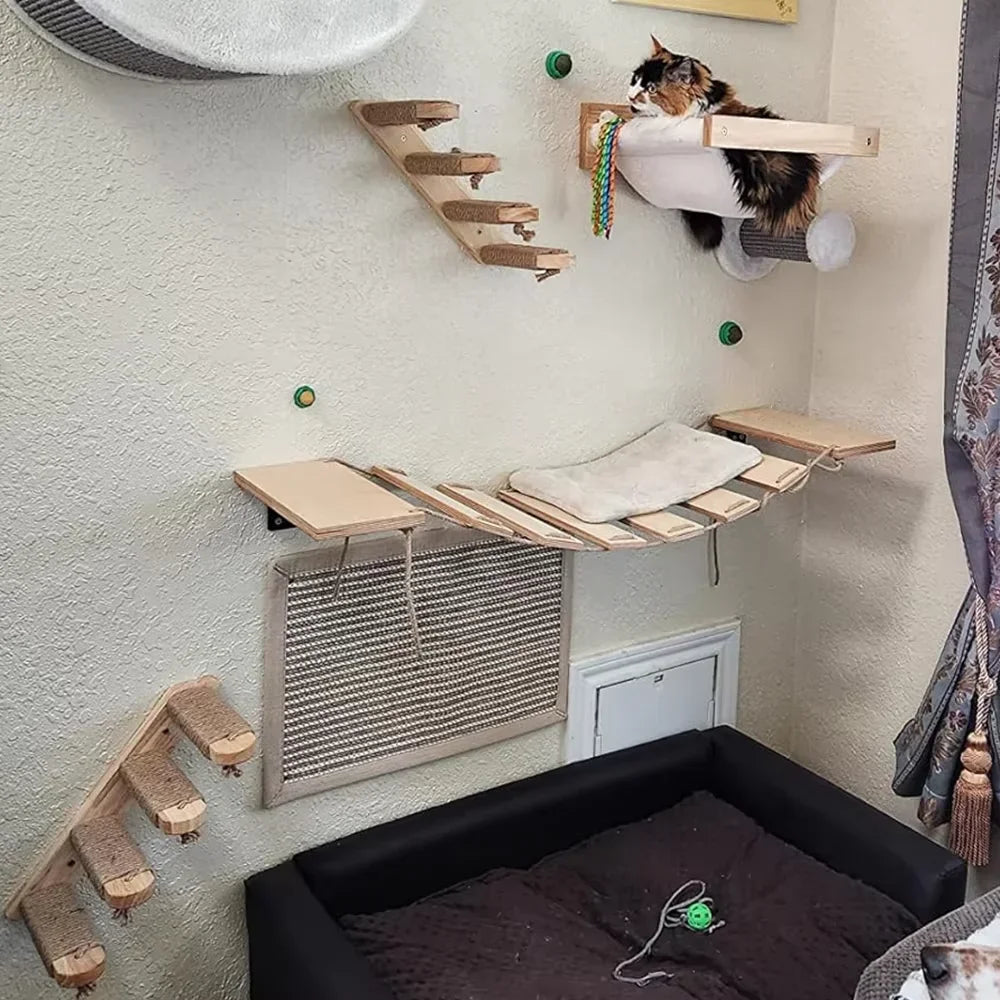 Cat playing on a wooden cat shelf with various platforms and a black cat bed below.