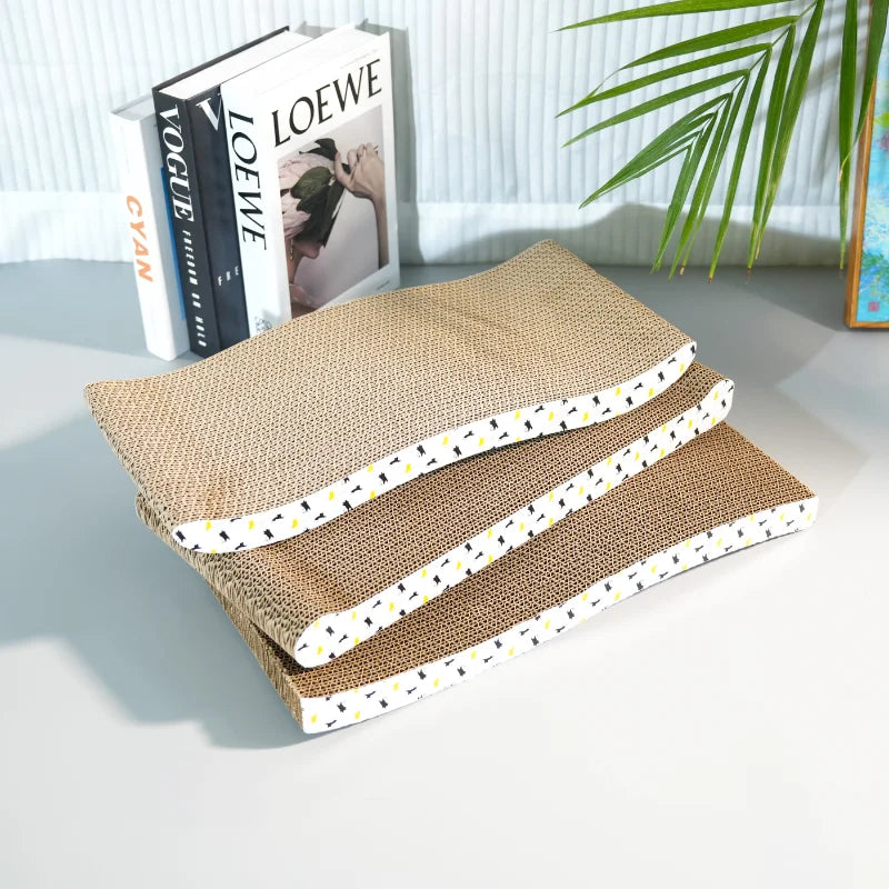 Three woven cat scratchers stacked on a white surface with books and a plant in the background.