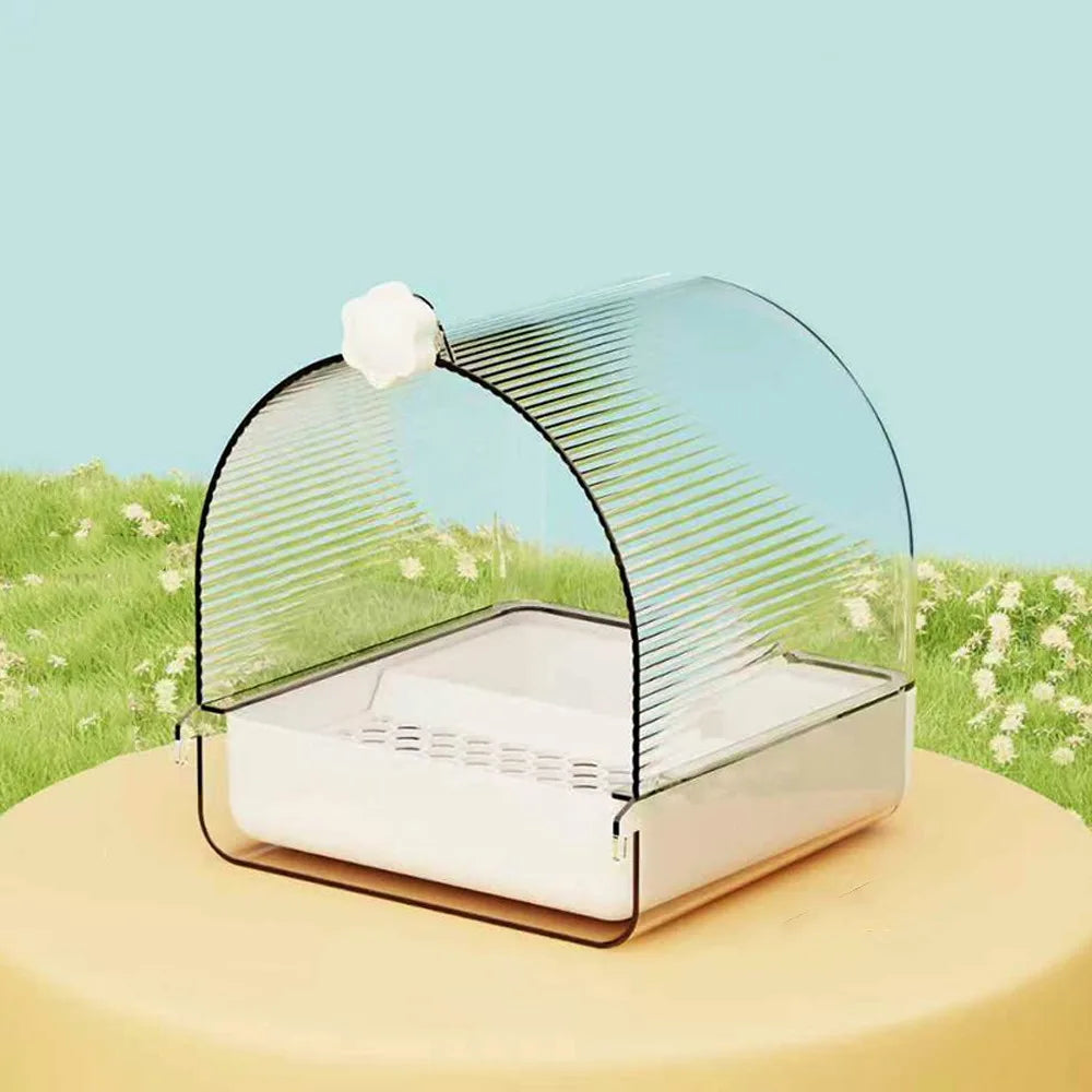 Clear pet carrier with a white ball on a grassy background
