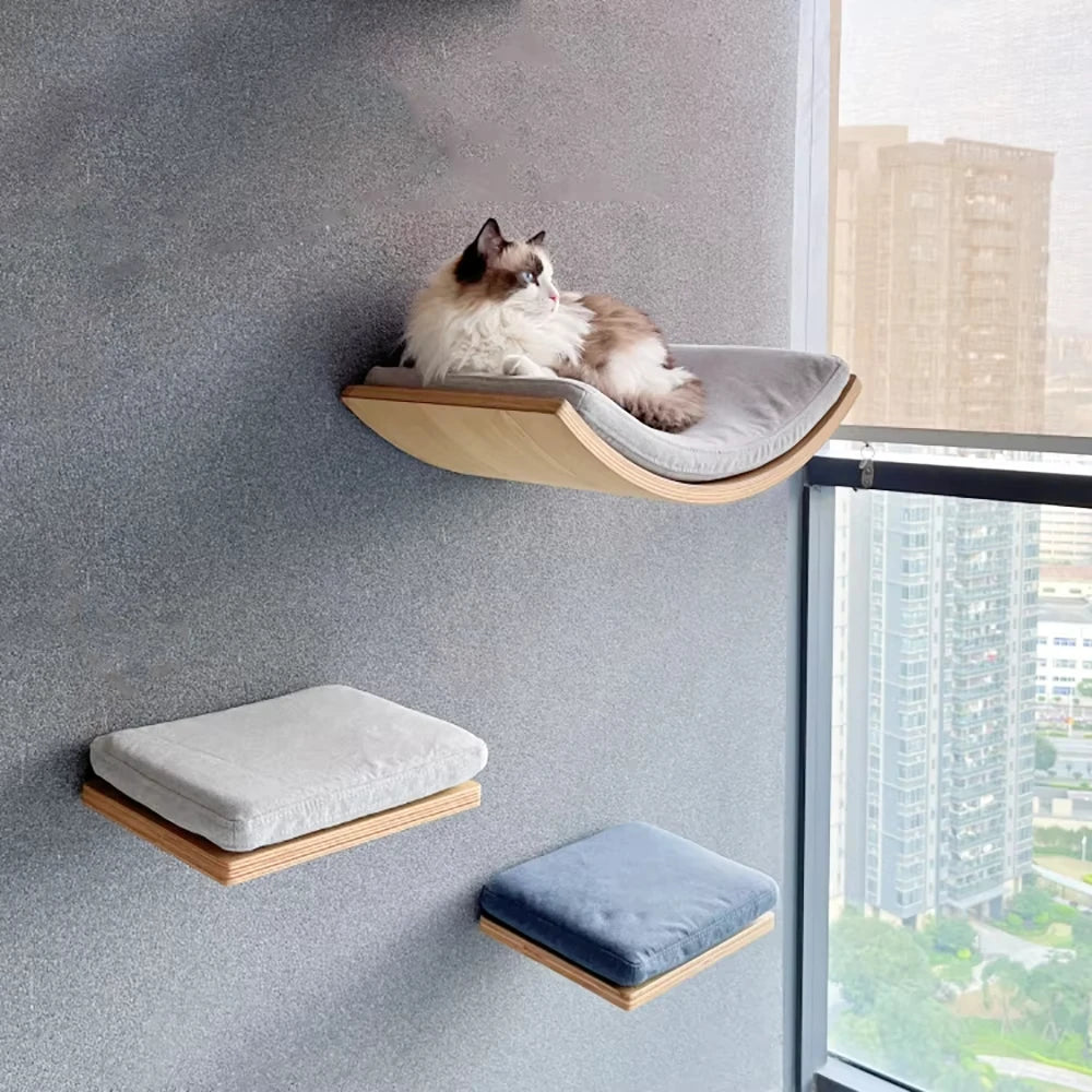 Cat lounging on a wall-mounted pet bed with additional beds below in a modern interior.