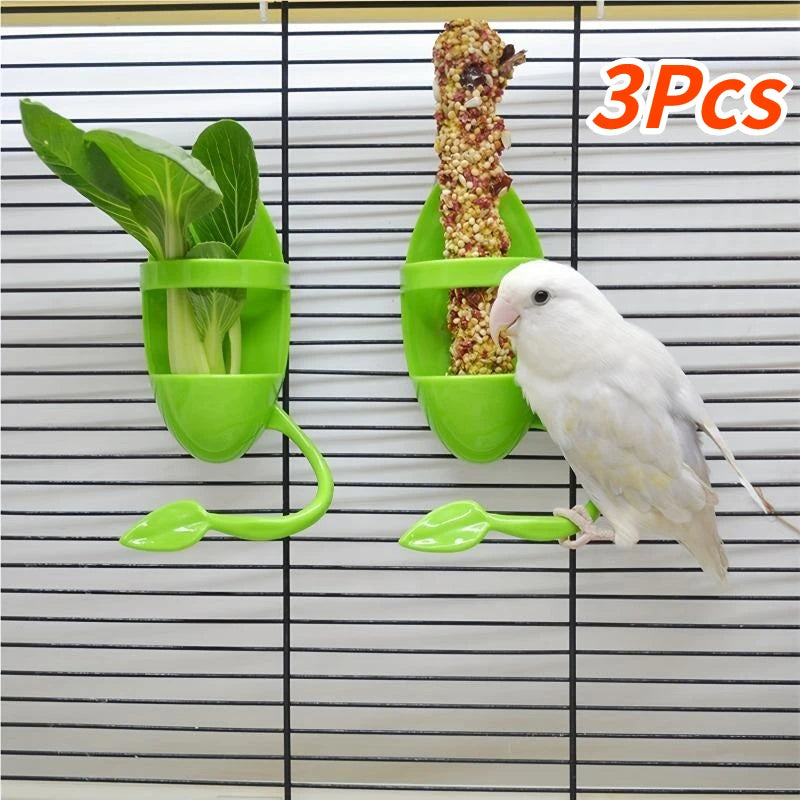 Three green bird feeders attached to a cage with a white parakeet interacting with one of them.