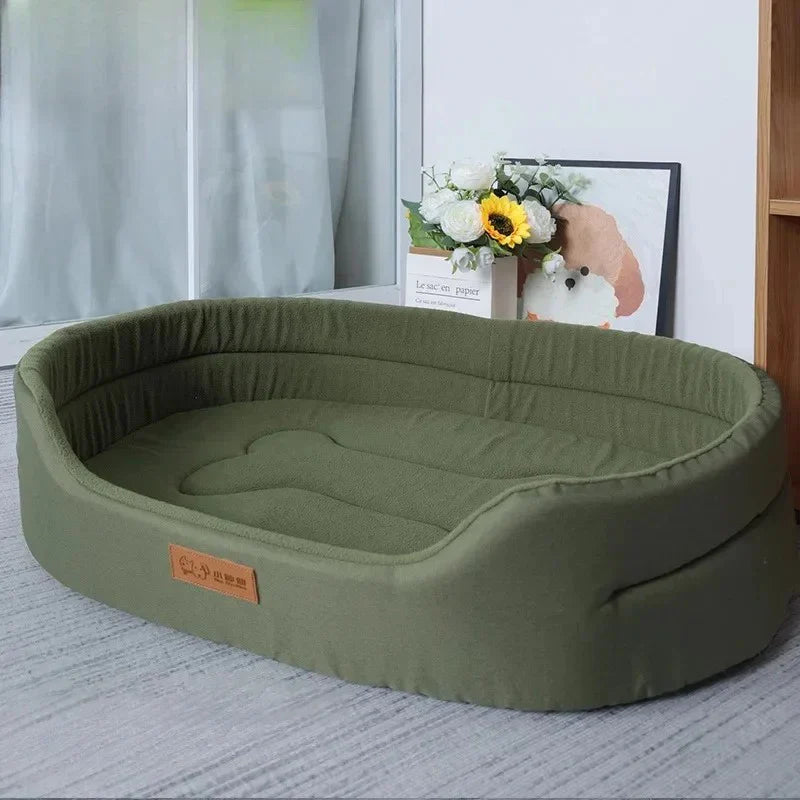 Green pet bed on a light gray floor with a blurred background