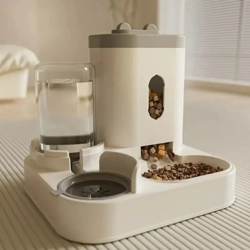 Pet feeding and water station with food and water containers on a wooden floor.
