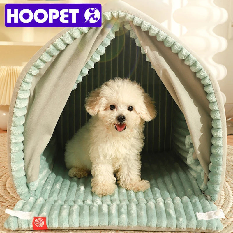 Small white dog inside a light green pet tent with 'HOOPET' branding.
